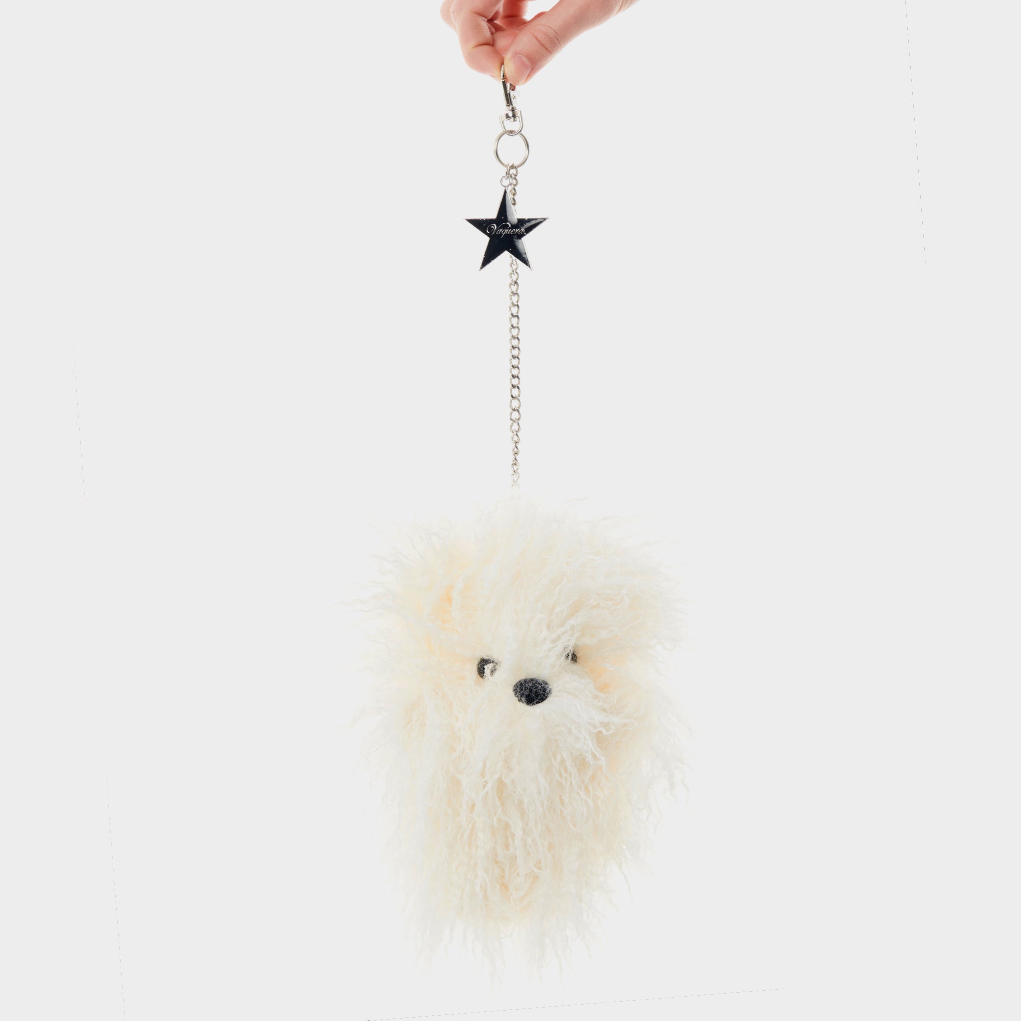 Photo of model holding a Furry Teddy Keychain - Cream.