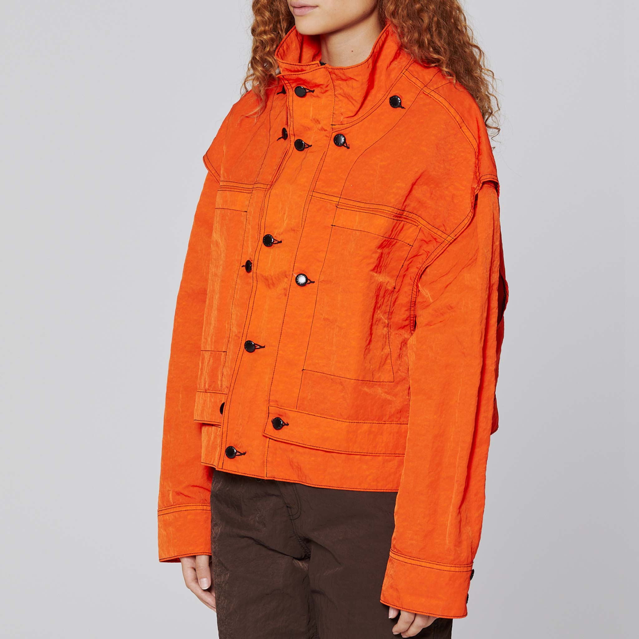 Side detail photo of model wearing the Mobile Jacket - Flame .